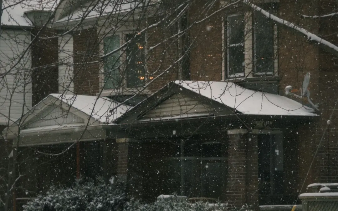 A home under heavy snowfall late at night as the warning lands