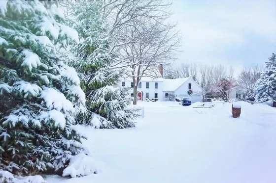 Snow-covered home and yard in a residential neighbourhood